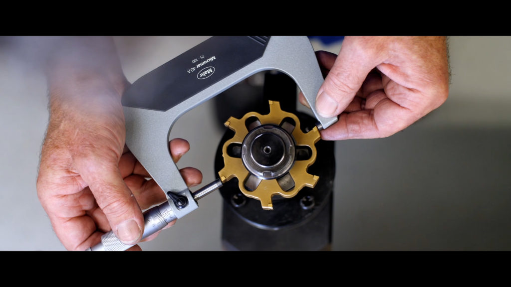 cutting ring reamer being measured by micrometer